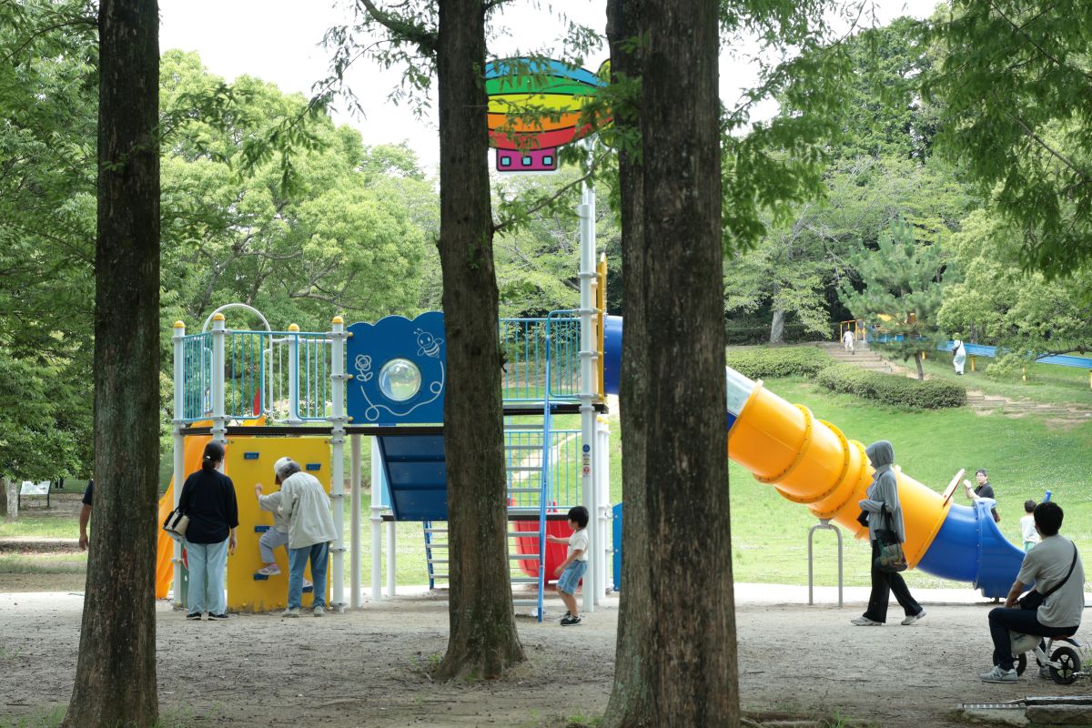 Children and families enjoying a small neighborhood park in Japan