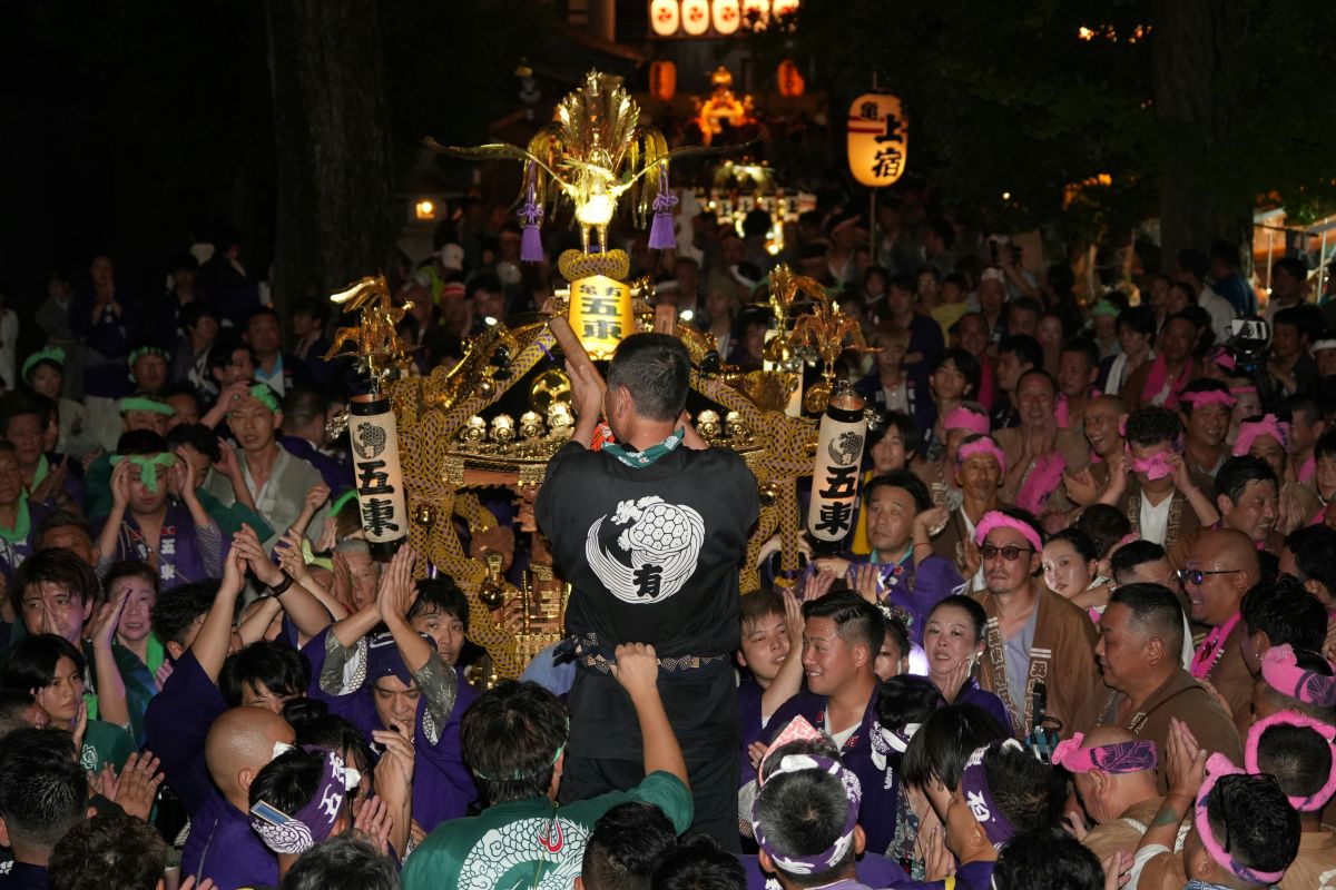 People carrying a mikoshi during a traditional shrine festival in Japan