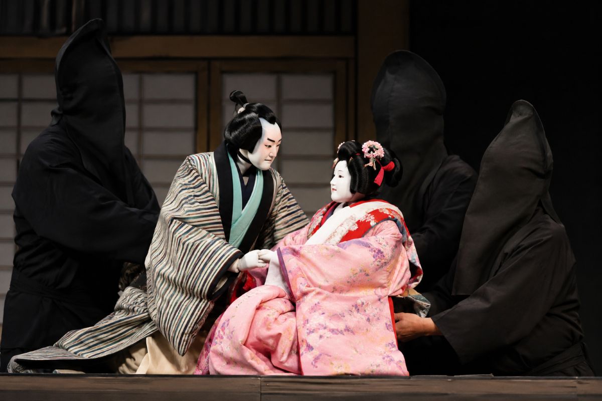 Bunraku puppets performing on a traditional Japanese theater stage