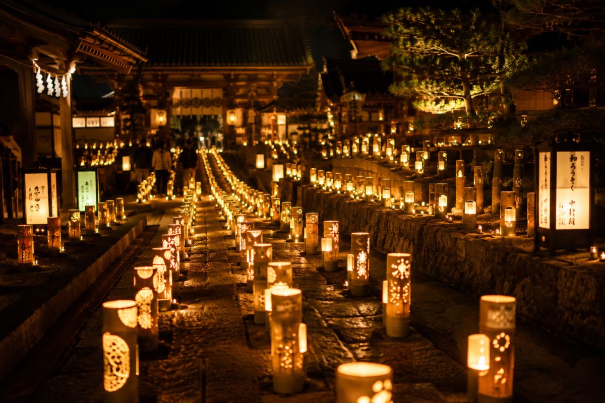 Historic Japanese street illuminated by hundreds of traditional candles at night
