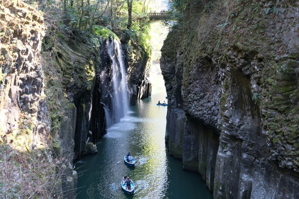 Peaceful Japanese mountain valley with a clear emerald river surrounded by dramatic cliffs