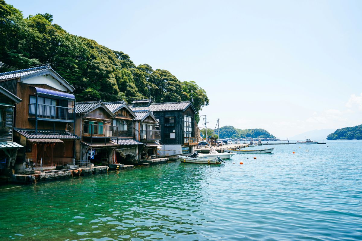 Traditional coastal fishing village with wooden boat houses and fishing boats in Japan
