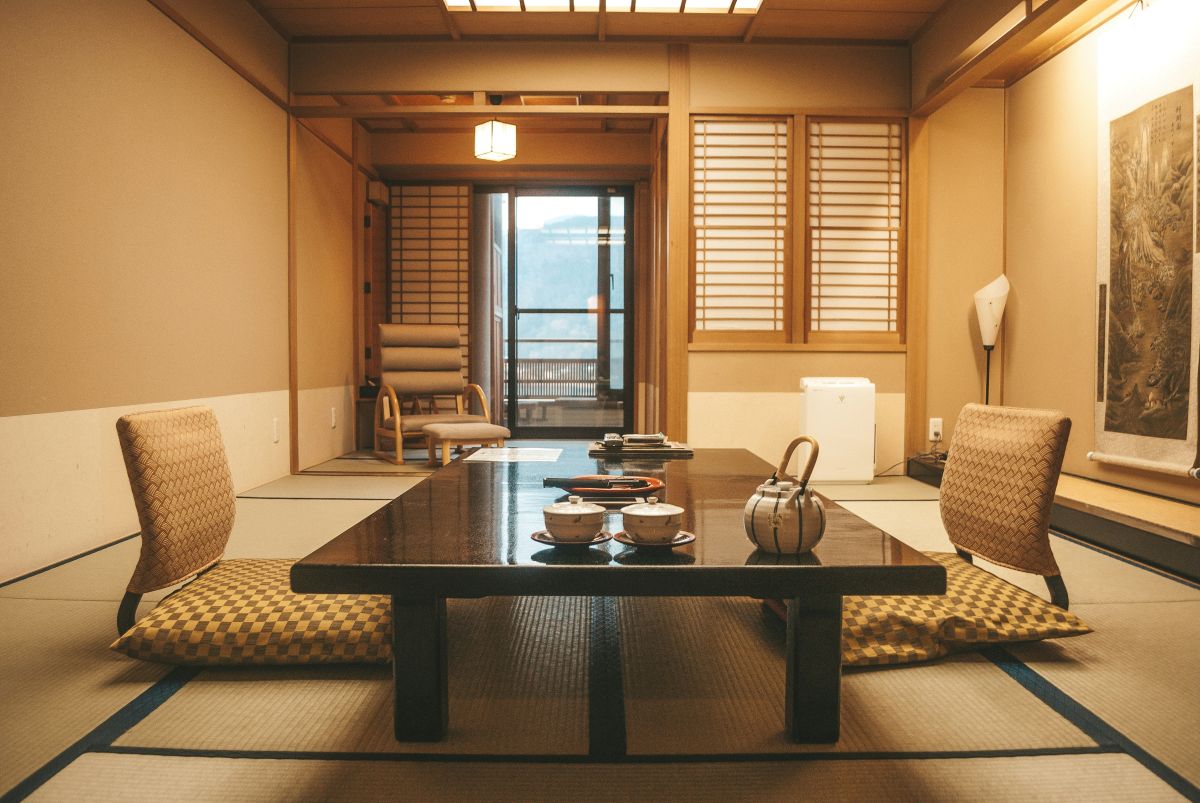 A traditional Japanese ryokan with tatami rooms, sliding doors, and a peaceful garden.