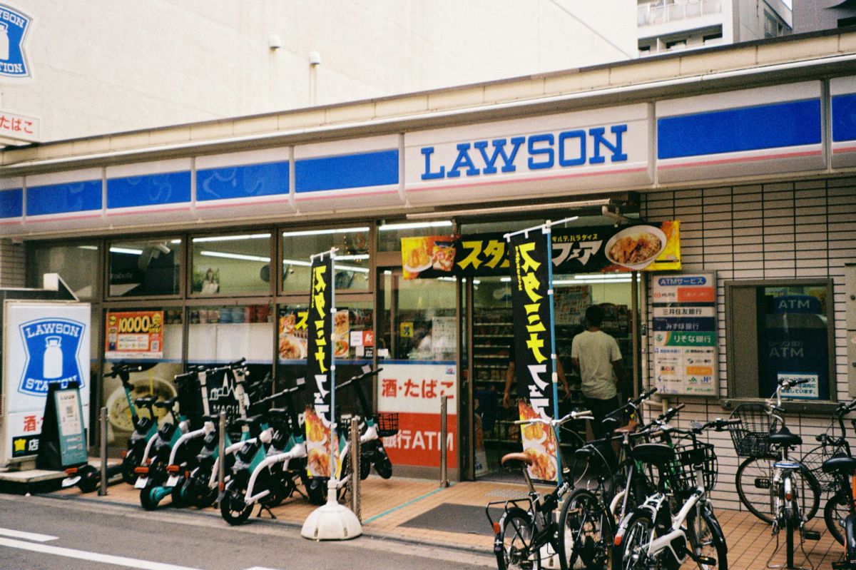A selection of Japanese convenience store desserts, including pudding, cream puffs, cheesecake, and seasonal sweets.