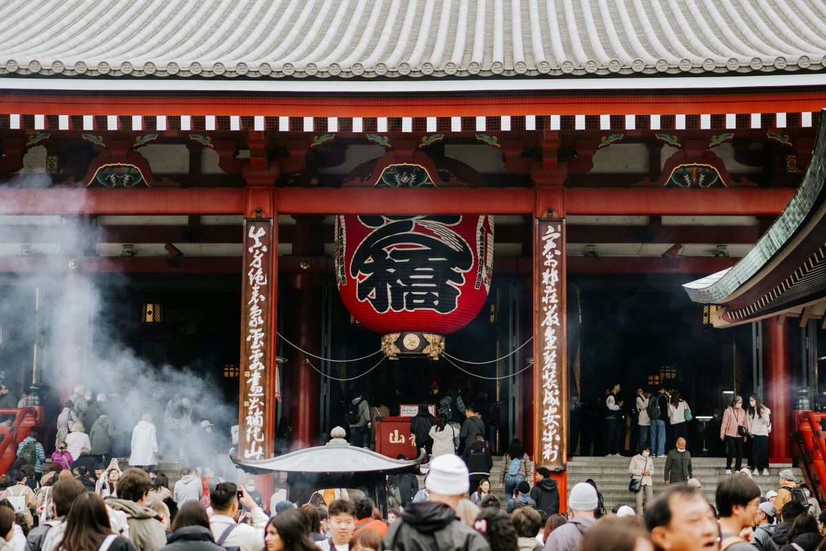 Visitors praying at a Japanese shrine during Hatsumōde, the first shrine visit of the New Year.