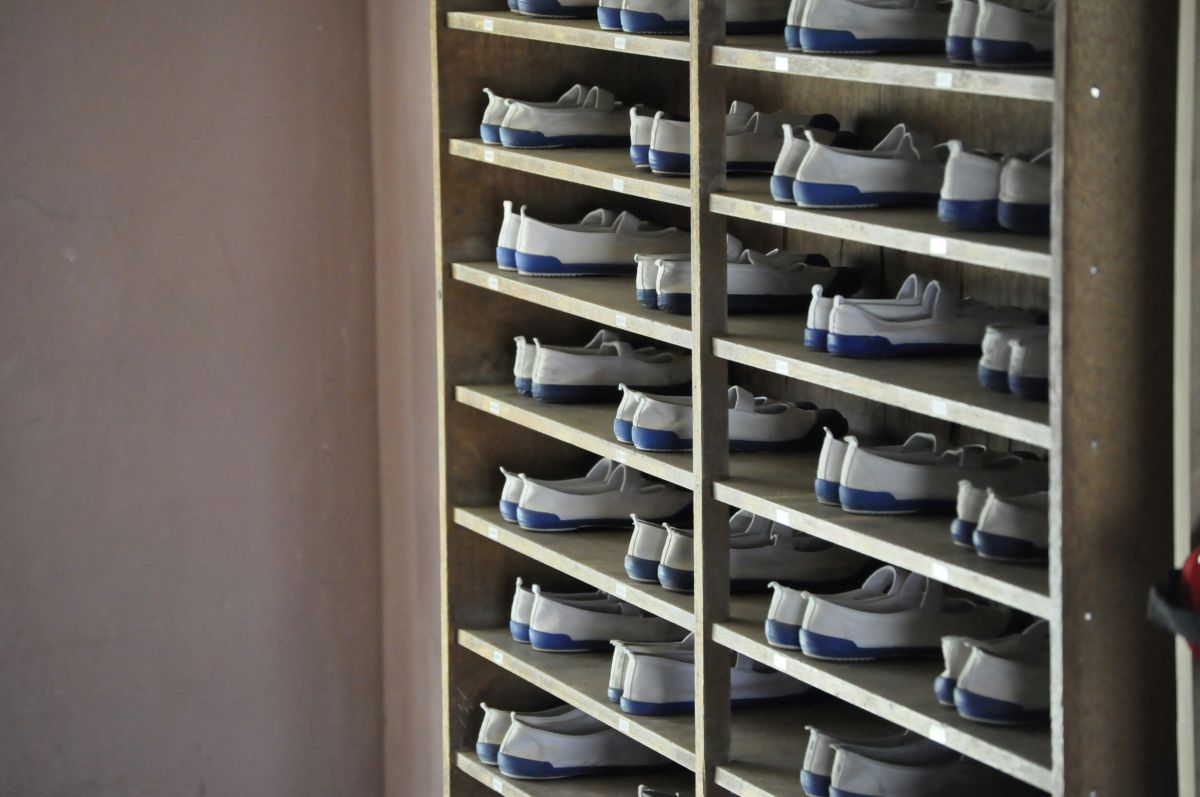 Japanese students changing from outdoor shoes into indoor shoes called uwabaki at the entrance of a school.