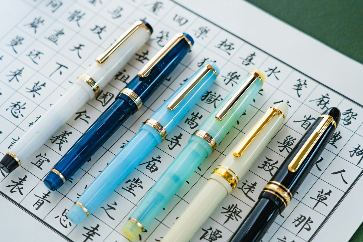 Japanese pens and a notebook on a wooden desk