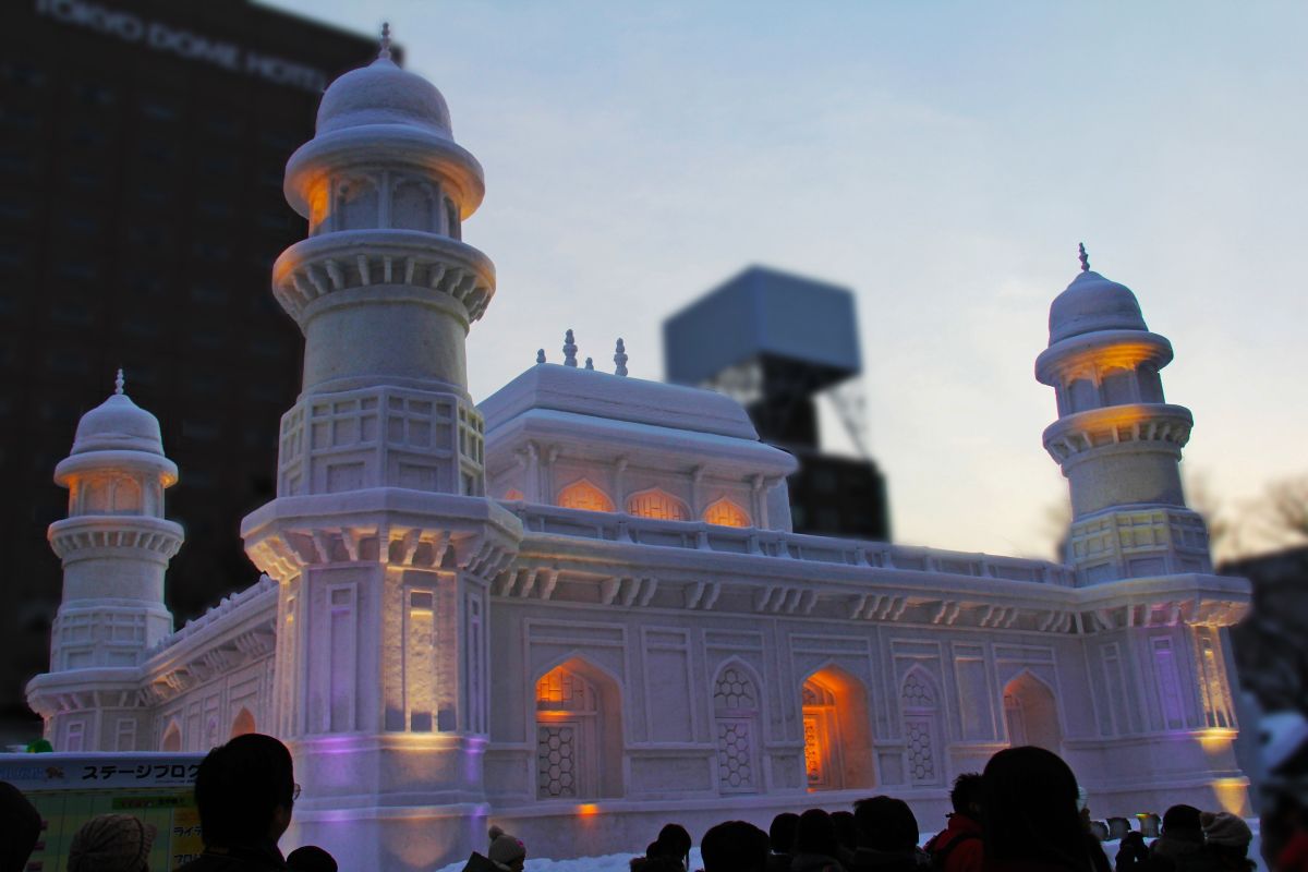 Visitors admiring giant snow sculptures at a Japanese snow festival