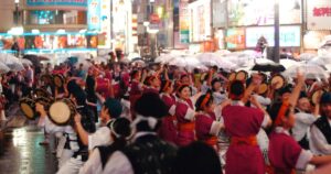 Traditional Japanese performers entertaining visitors at a lively street festival