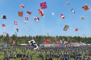Large traditional Japanese kites flying during a lively spring festival
