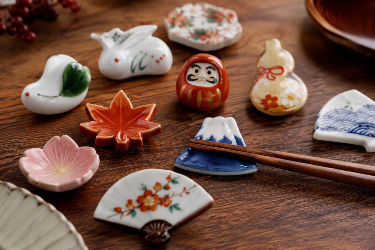 Handcrafted Japanese ceramic chopstick rests with elegant seasonal designs on a wooden table