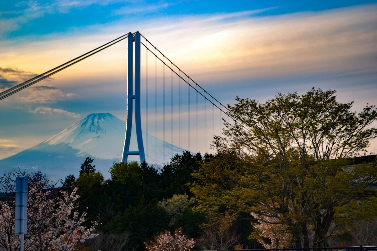 Long suspension bridge stretching across a beautiful mountain valley in Japan