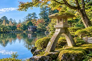 Traditional Japanese stone lantern surrounded by moss, pine trees, and a peaceful garden pond